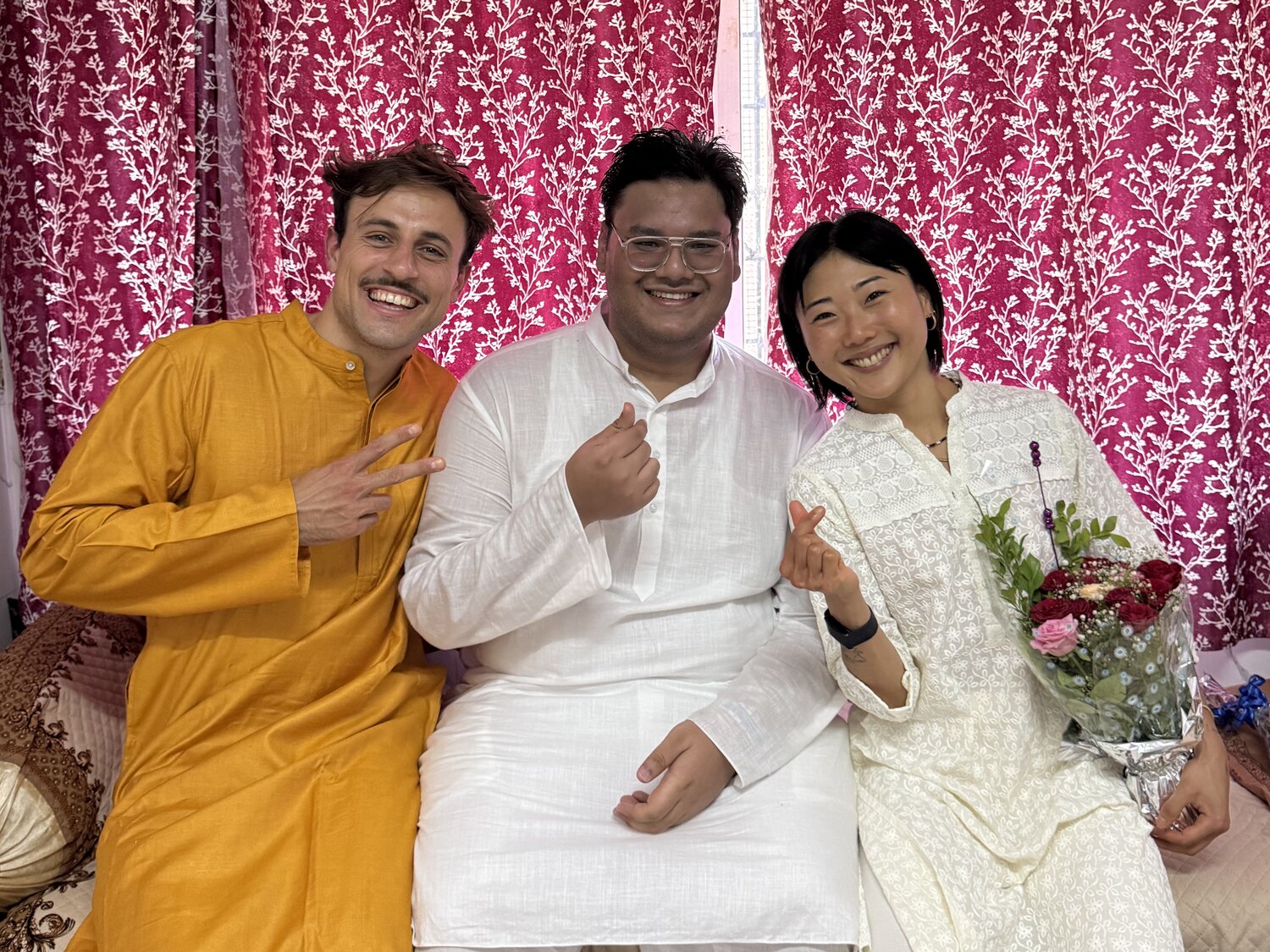 Marc Lou, Wahab Shaikh and Wonji sitting together in kurtas in a living room in India